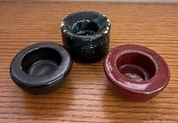 Top view of three round candle holders displaying colors and interior wells