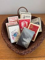 Overall view of wicker basket filled with assorted playing-card decks