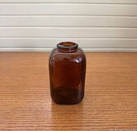 Amber square glass bottle standing upright