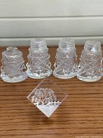 Front view of four crystal shakers and lucite block