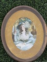 Front view of oval framed lady portrait