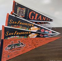 Stacked view of four Giants pennants
