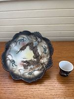 Top view of moriage dish and sake cup showing dragon design and size relationship