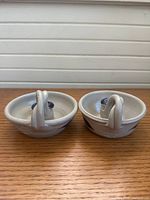 Pair of ceramic candle holders side view showing loop handles and glaze