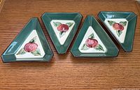 Four triangular dishes displayed side by side