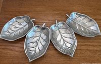 Overhead view of the four metal leaf dishes