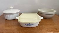 Front view of all three kitchen pieces: Cornflower casserole, French White casserole, stoneware bowl