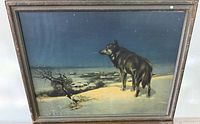 Full view of framed Lone Wolf print, glass glare visible