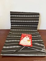 Full view of folded fabric length showing overall pattern and label