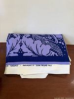 Folded fabric showing selvage text "Fandango" and Marimekko details