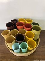 Top view of assorted color tumblers nested in beige holder