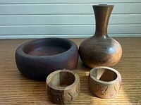 Bowl, vase, and two small carved cups displayed together