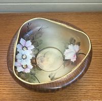Top view showing floral interior, curled rim, gold gilt