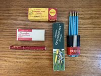 Overview of all five vintage office supply items on wood surface