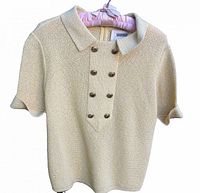 Front view of knit top showing collar, button panel and texture