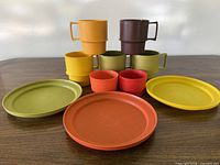 All items grouped—six handled mugs, two tumblers, three plates