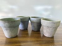 Front view of four matching clay pots