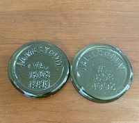 Front view of both green glass discs showing 1990 and 1992 embossing