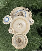 Top view of all six stoneware crock lids showing sizes, band colors and handle styles