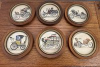 Front view of six round framed prints arranged in two rows