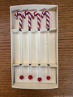 Four glass swizzle sticks in original box