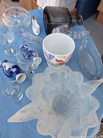 Group shot showing all assorted glass and ceramic items on blue cloth