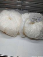 Two skeins of off-white SRK Candy Floss yarn