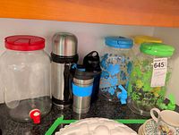 Group shot showing three beverage dispensers, vacuum flask, travel mug and water bottle