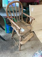 Front view showing spindle back, arms, legs, footrest