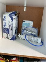 Aqua-Pure filter system box and components inside cabinet