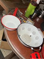 Pot and colander on table showing size and color contrast
