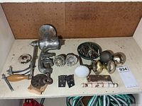 Shelf view showing meat grinder, knobs, hinges, screws