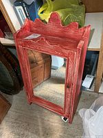 Front view showing mirrored door and red distressed wood