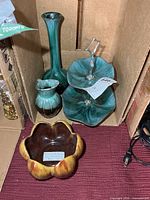 All four pottery pieces grouped in box
