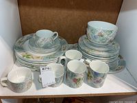 Stacked plates, bowls, cups and mugs showing pattern
