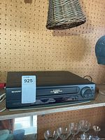 Front view of Sharp VHS player showing brand, 4-Head marking and cassette door