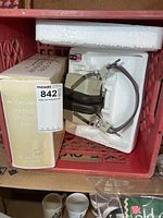 Headphones in styrofoam next to original Archer box
