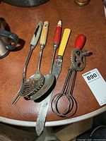 Group view of all vintage utensils and egg beater