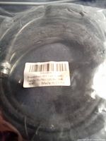 Cable coiled in sealed bag showing label and connector