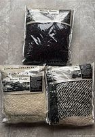 All three sealed Casco Bay Collection woven throw blankets