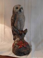 Full view of ceramic owl figurine on branch showing size and base details