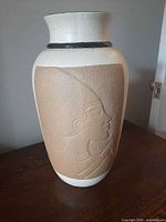 front view showing male profile relief on vase