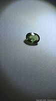 Top view of loose oval green sapphire