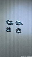 Four faceted aquamarines on white background