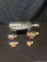Group view of all five ship-in-a-bottle models