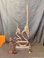 Group shot showing all three wooden sculptures for size and form reference
