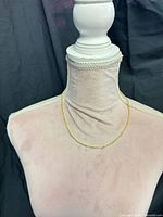 Necklace displayed on mannequin form showing overall appearance