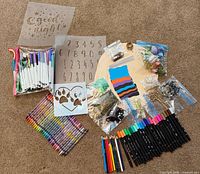 All items laid out including wooden rounds, markers, pencils, stencils and embellishments