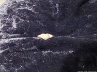 Ring on dark fabric background showing overall form