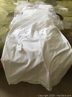 Full view of the white duvet cover laid out on a bed, showing the Battenberg lace inset on fabric.